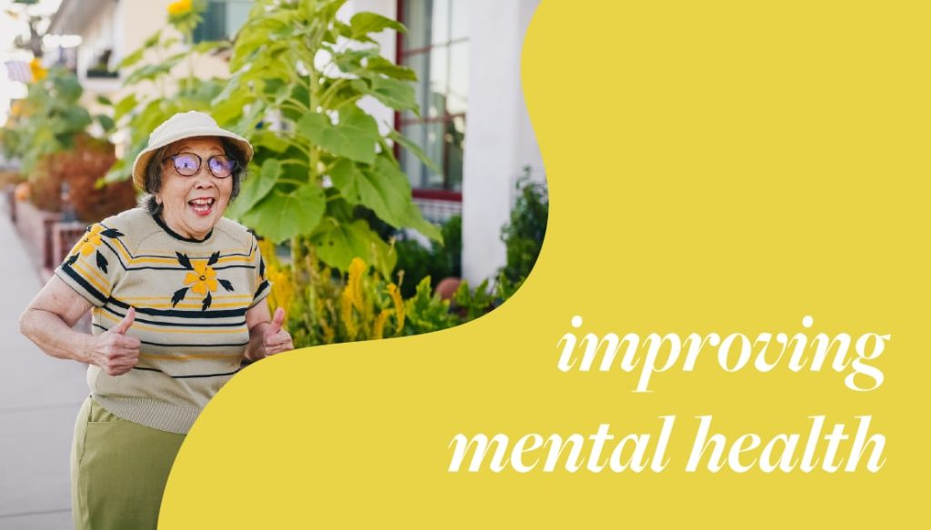 Elderly woman smiling and giving thumbs up outdoors, surrounded by greenery, with text "improving mental health" emphasizing positive mental well-being.