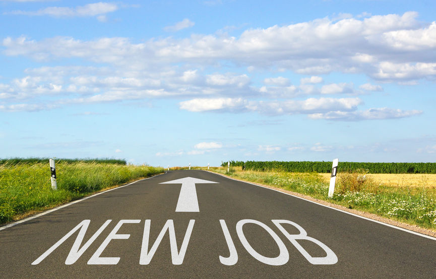 Road leading to a horizon with "NEW JOB" painted on the asphalt, symbolizing career advancement and job hunting opportunities.