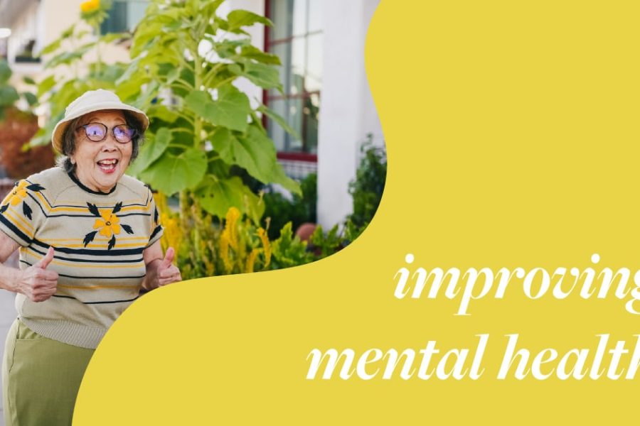 Elderly woman smiling and giving thumbs up in a garden, emphasizing themes of improving mental health.