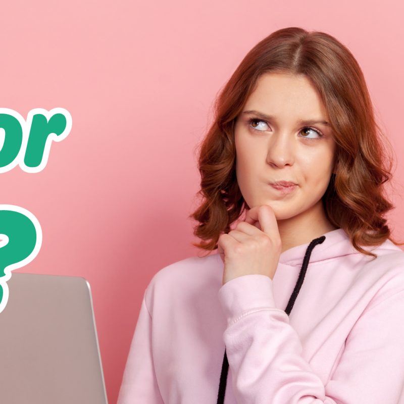 Young woman in a pink hoodie thinking thoughtfully, with a laptop nearby, reflecting on health insurance options like HSA or FSA.